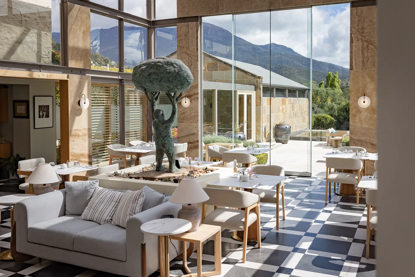 The glass conservatory dining room with checkerboard floor and Mount Wellington views