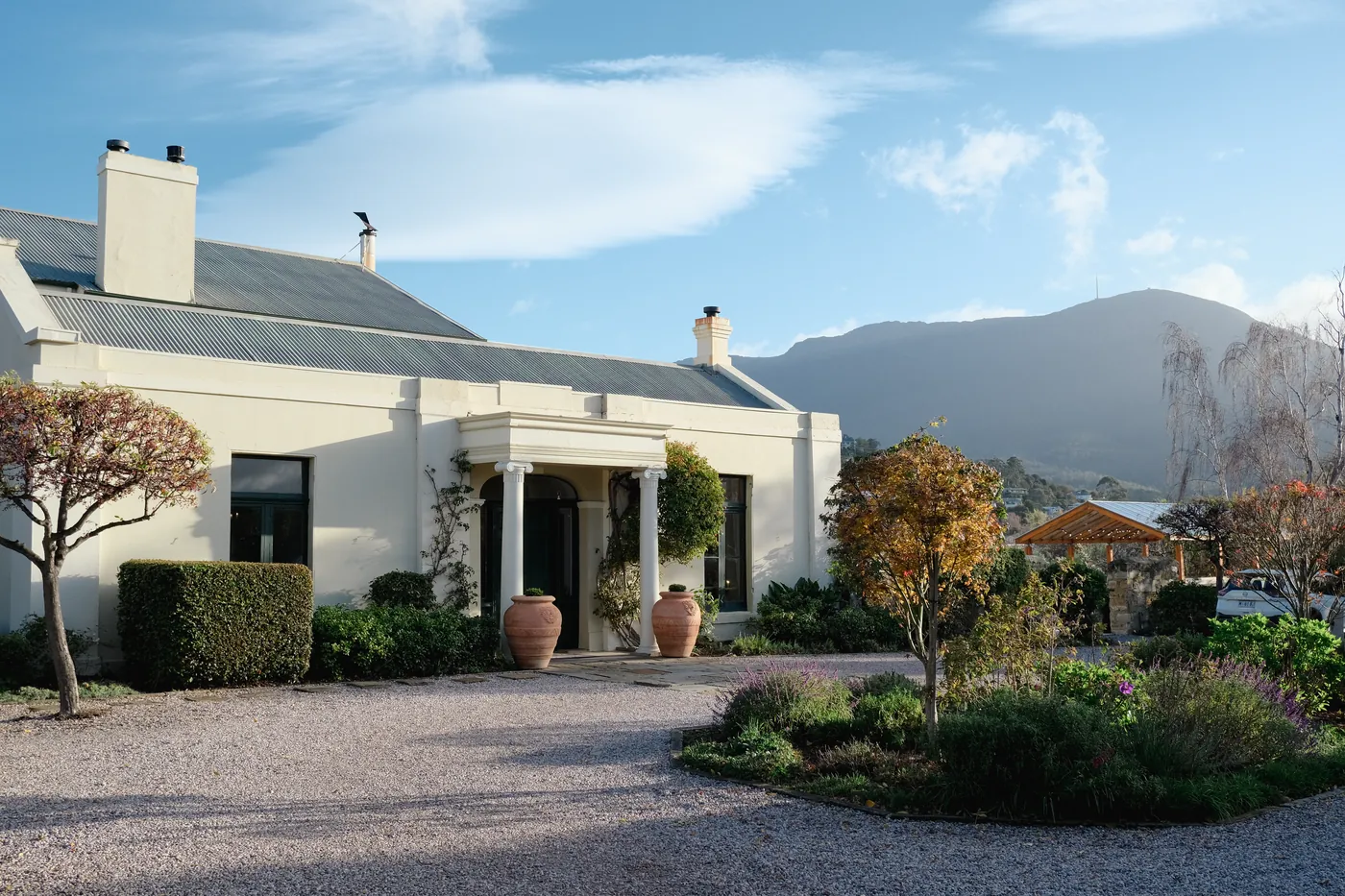 Islington Hotel's heritage facade and gardens beneath Mount Wellington