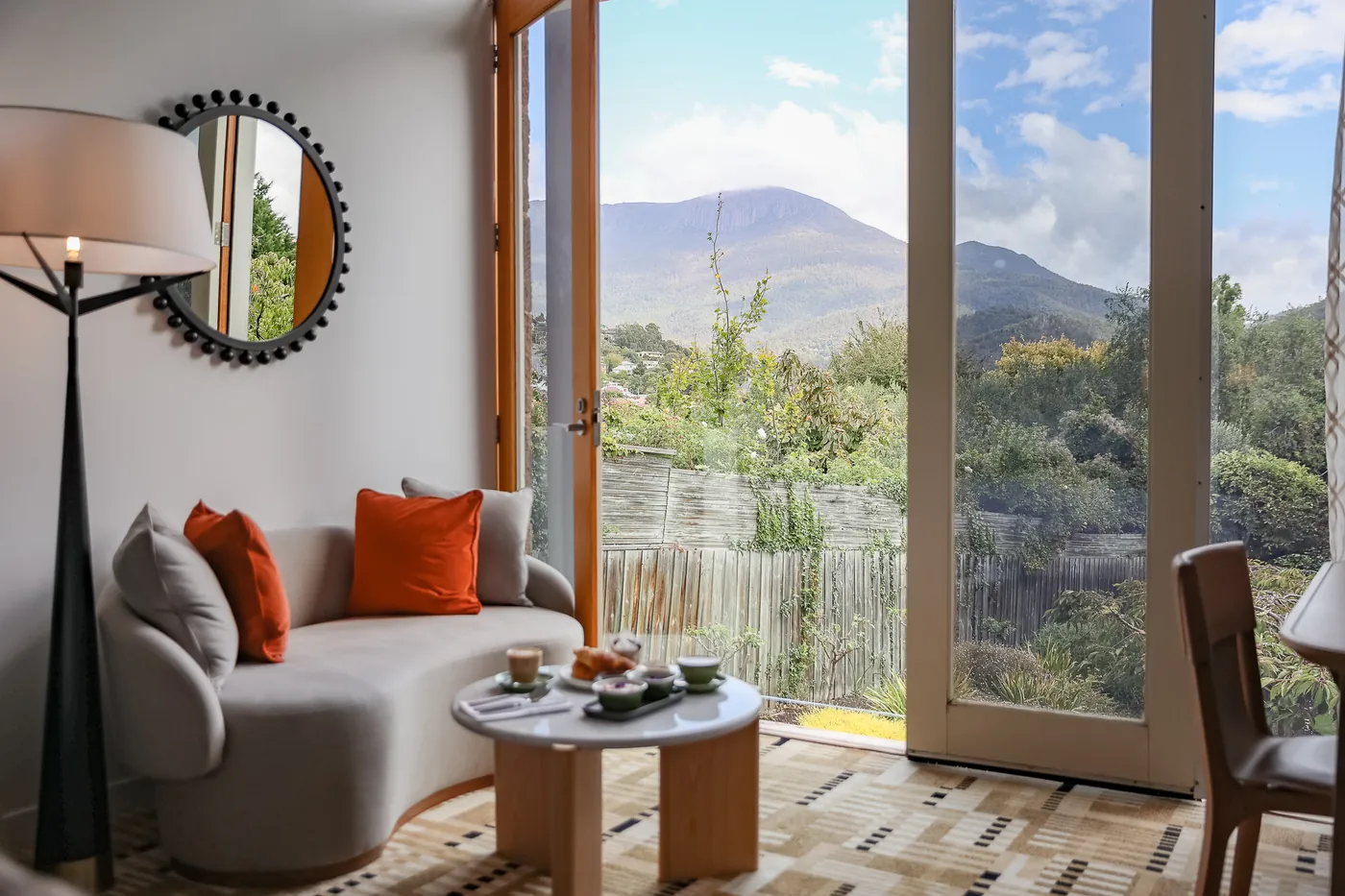 The Wellington Room lounge opening onto garden and mountain views